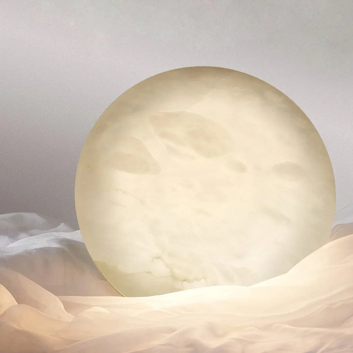 Side View of Illuminated Modern Oval Alabaster Wall Sconce Studio Shot