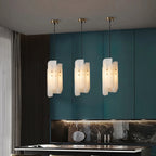Trio of Modern Alabaster Pendant Lights Over Kitchen Island