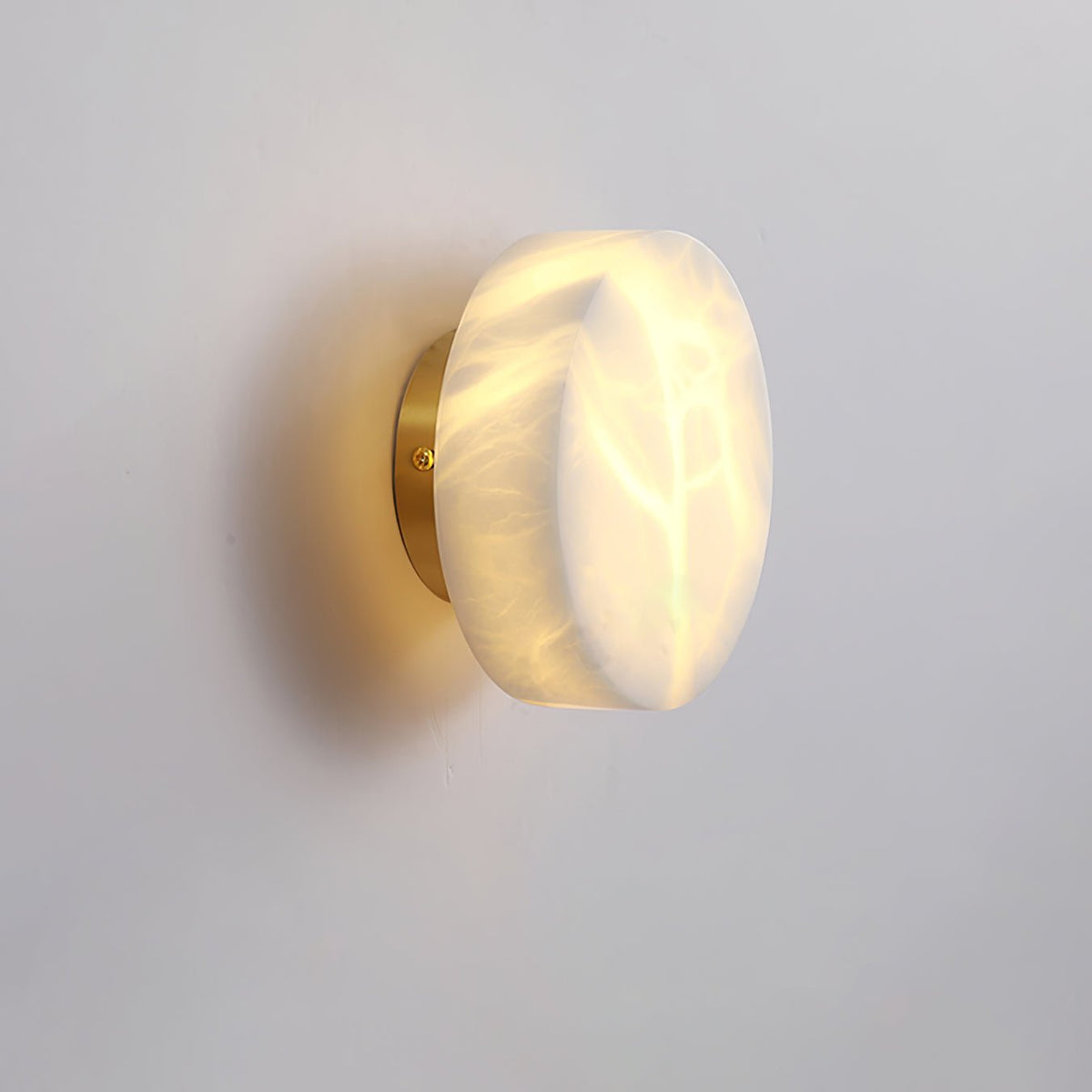 Side Angle View of Illuminated Brass Leaf Vein Alabaster Sconce