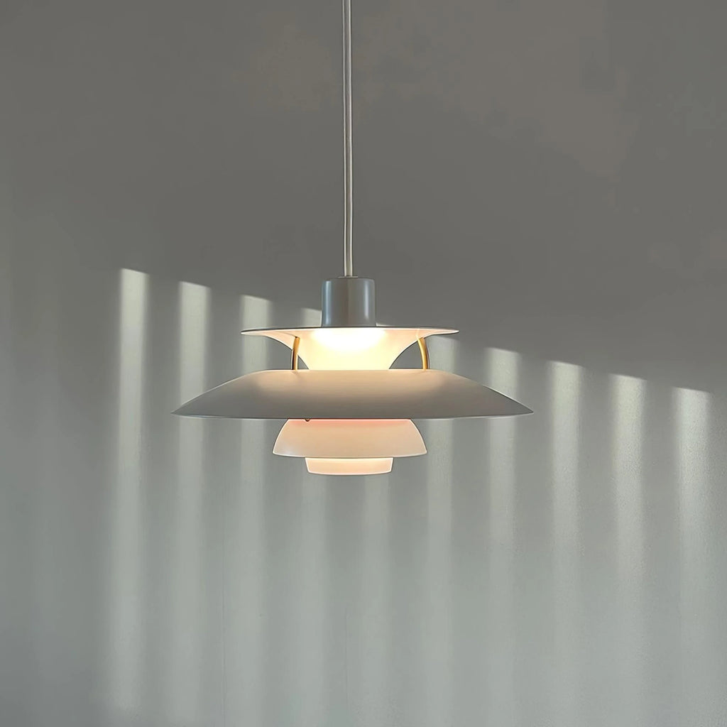 Illuminated Modern Nordic Pendant Light Casting Light Patterns on Wall