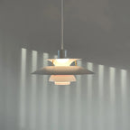 Illuminated Modern Nordic Pendant Light Casting Light Patterns on Wall