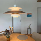 Modern Nordic Pendant Light Over Round Dining Table with Artwork