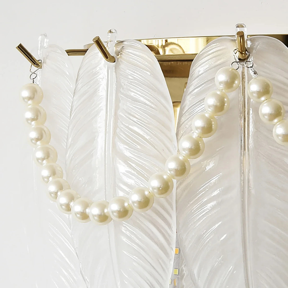 Close Up View of Frosted White Feather Wave Art Glass and Delicate Pearl Strand Details