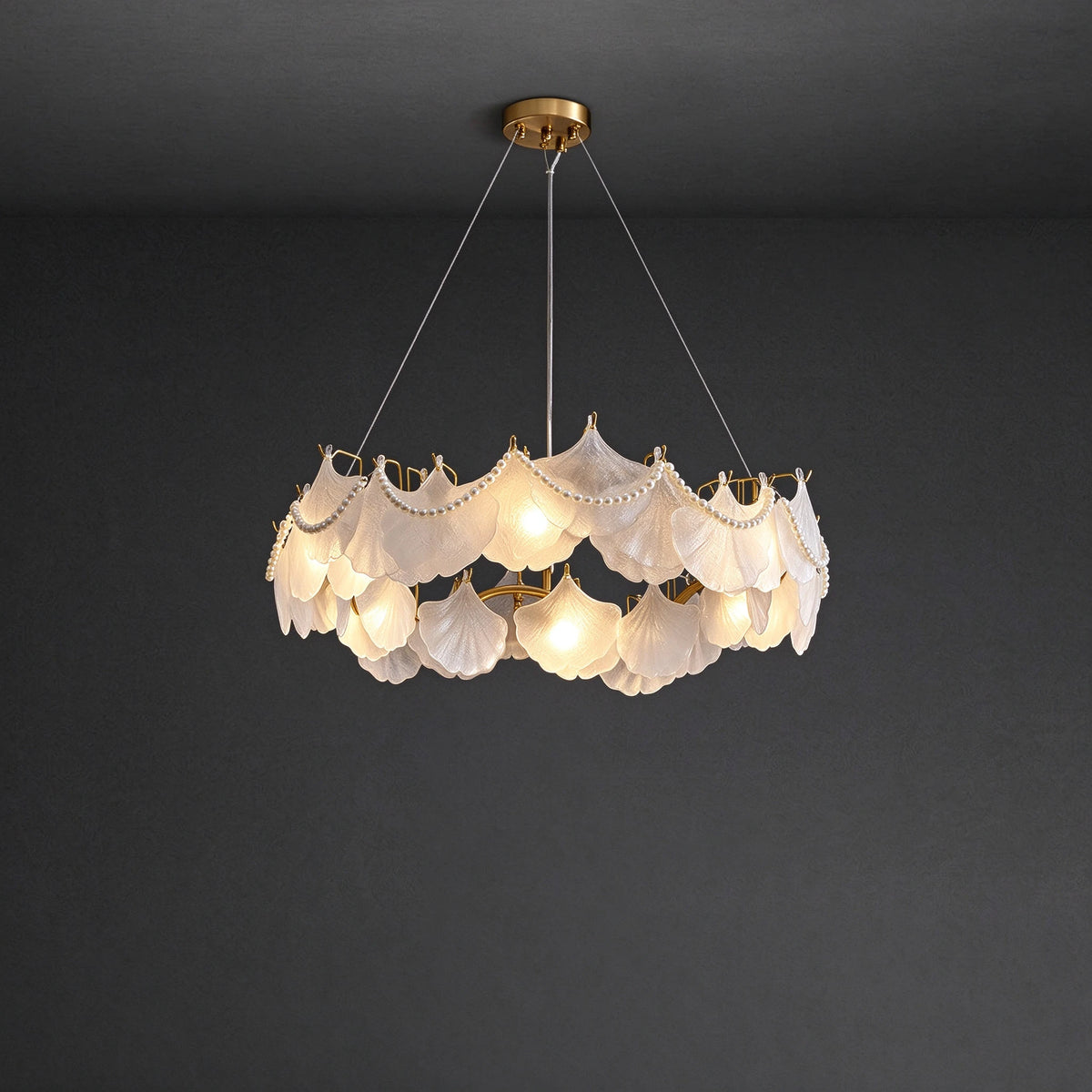 Illuminated Modern Frosted White Feather Wave Chandelier with Pearl Strand Studio Display on Black Background