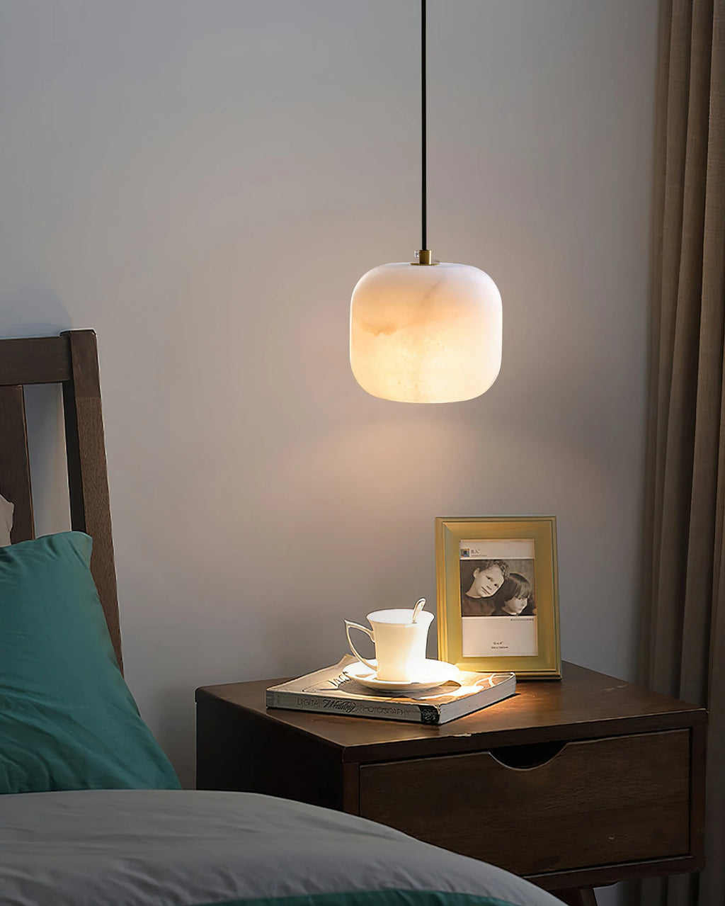 Illuminated Modern Soft Rounded Alabaster Pendant Light Over Nightstand