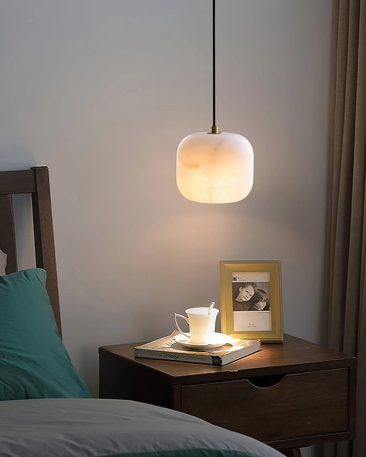 Illuminated Modern Soft Rounded Alabaster Pendant Light Over Nightstand