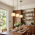 Modern Soft Rounded Alabaster Pendant Lights Over Dining Table
