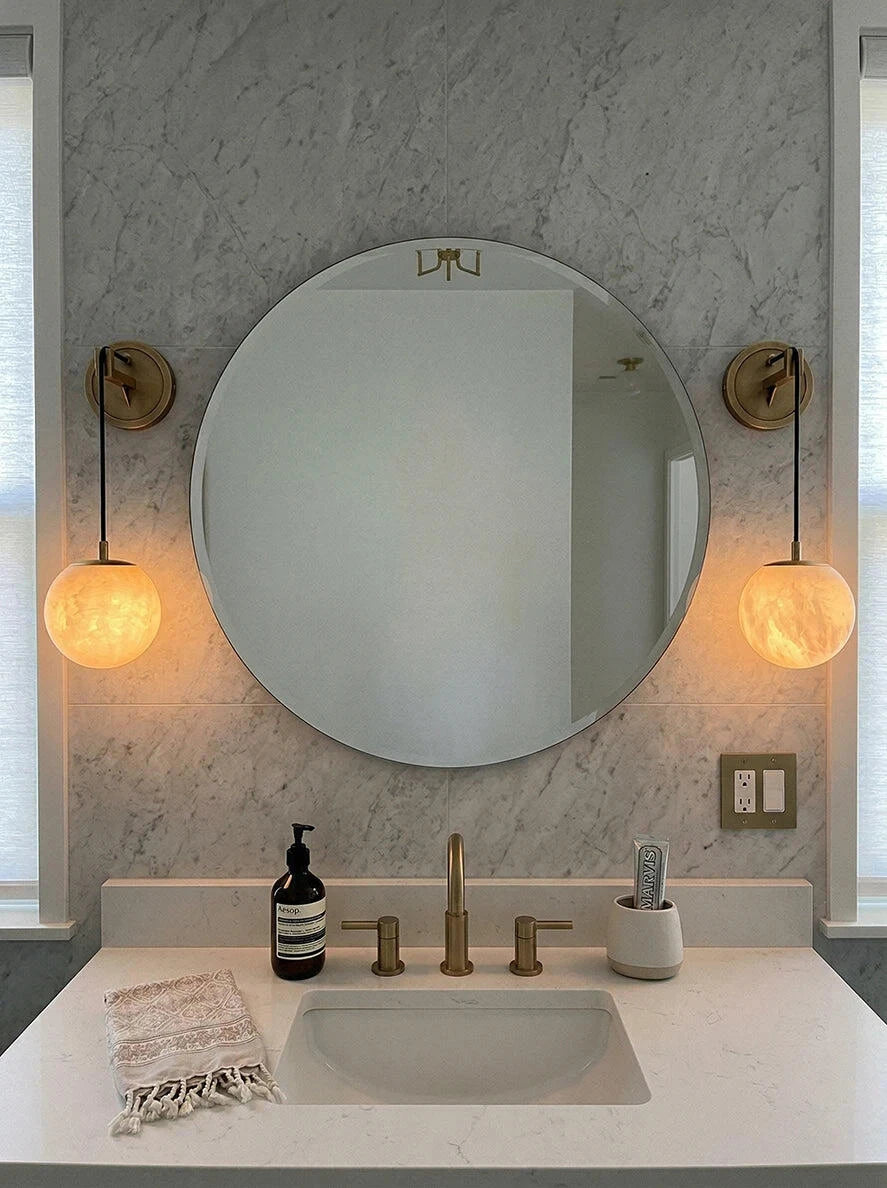 Pair of Brass Alabaster Globe Vanity Sconces beside Bathroom Mirror