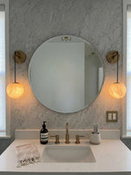 Pair of Brass Alabaster Globe Vanity Sconces beside Bathroom Mirror