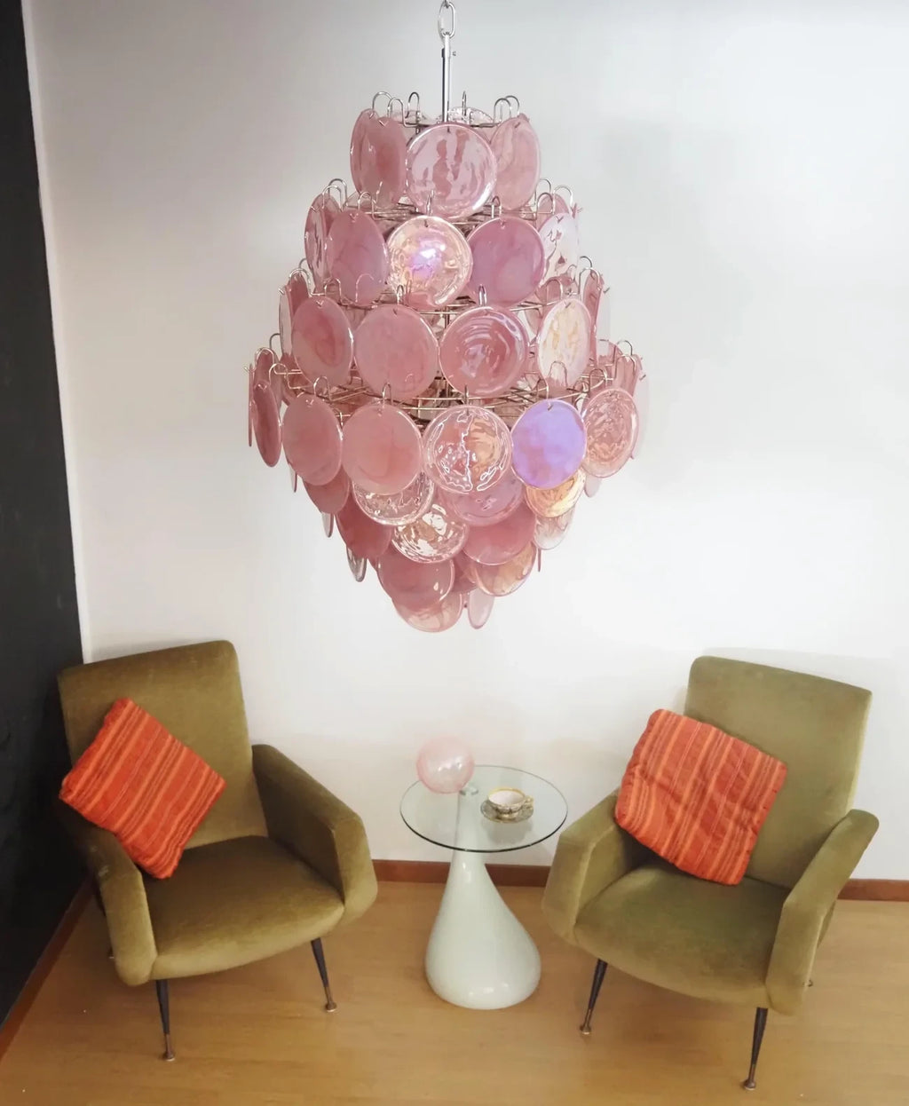 Modern Pink Disc Art Glass Chandelier Over Living Room Seating Area