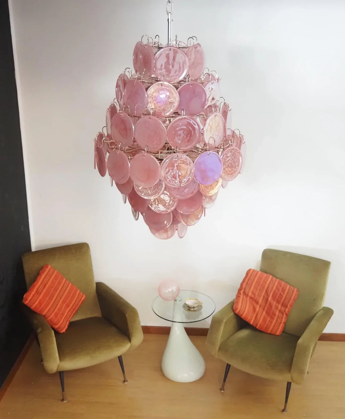 Modern Pink Disc Art Glass Chandelier Over Living Room Seating Area