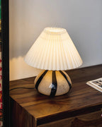 Illuminated Pleated Shade Lamp on Dark Wooden Console