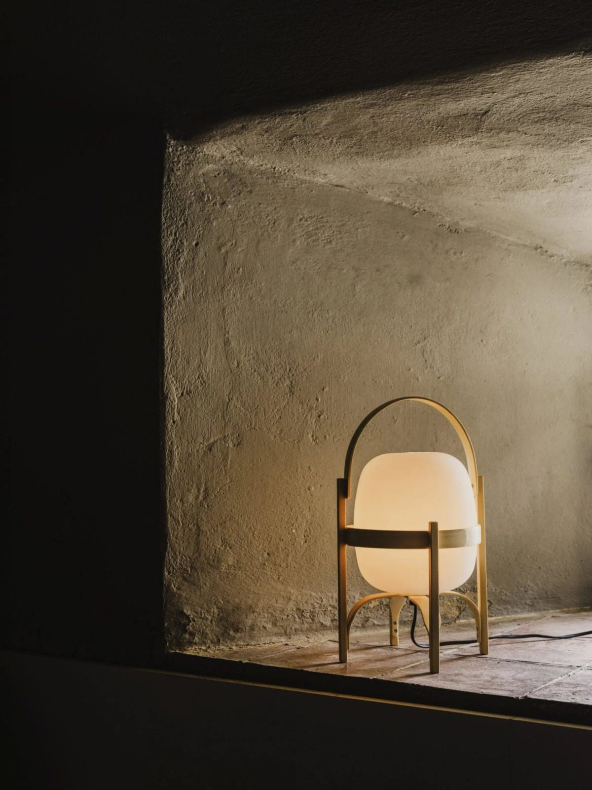 Illuminated Wooden Handle Table Lamp in Dark Interior Setting