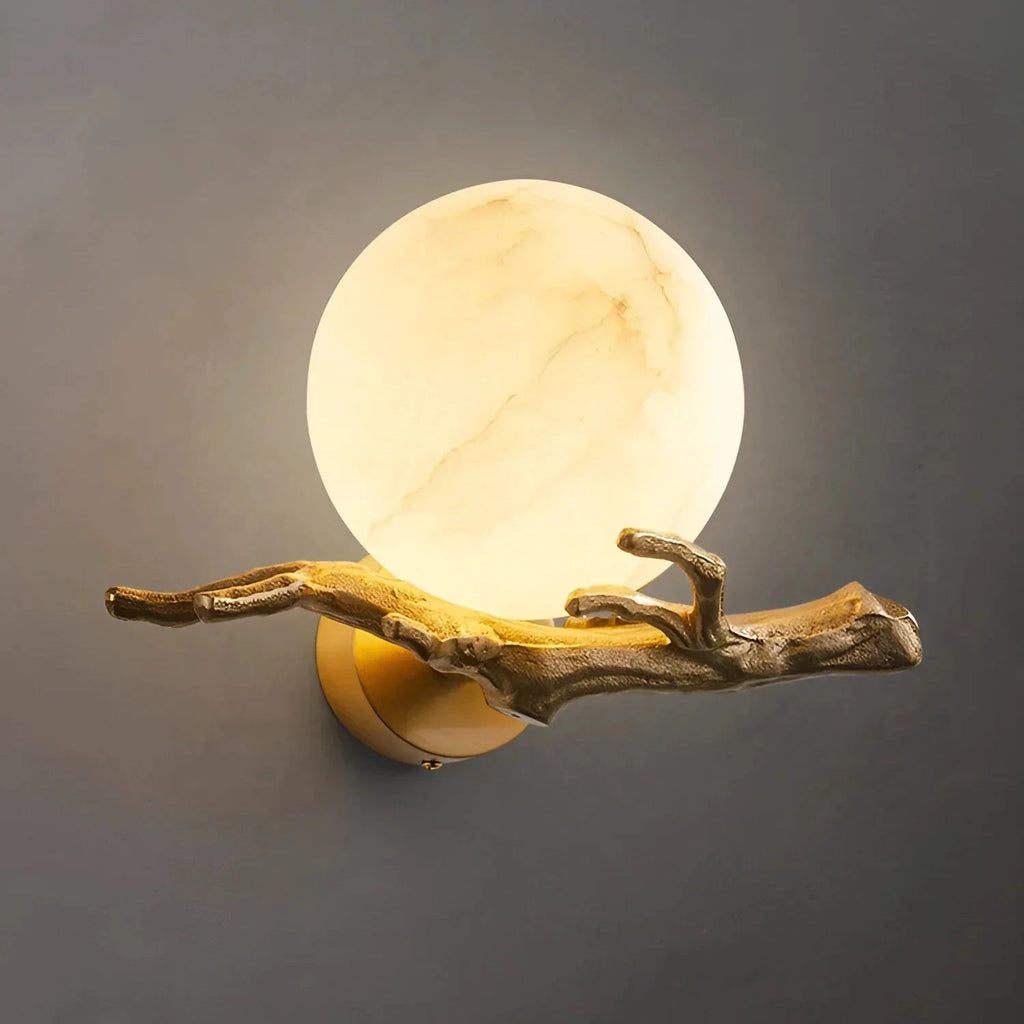 Close Up View of Glowing Alabaster Sphere and Brass Branch Mount
