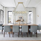 Modern Dining Room with Gray Chairs Installation of Glass Chandelier