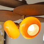 Close Up View of Illuminated Orange Glass Shade and Fixture Details