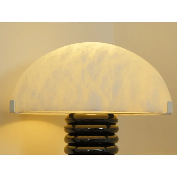 Close Up View of Glowing Marble Shade and Black Base