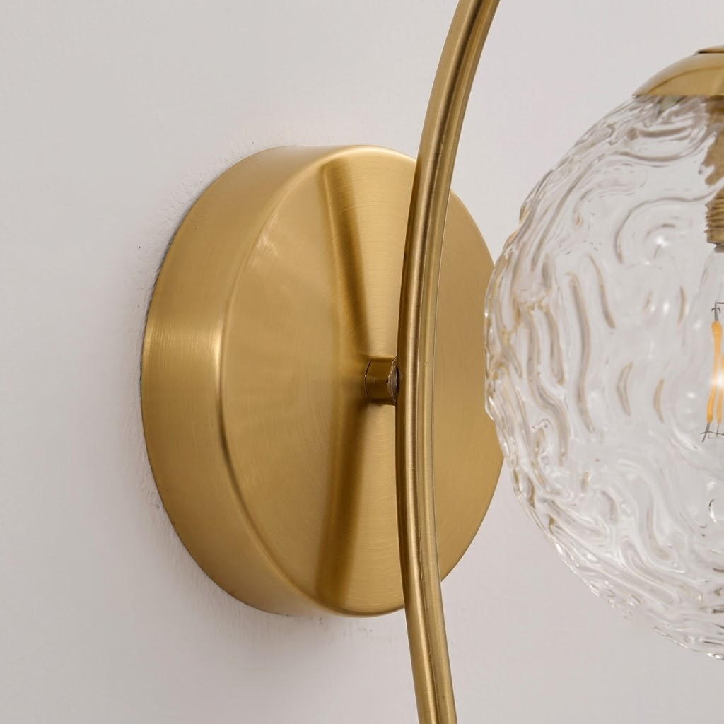 Detail View of Brushed Brass Backplate and Curved Light Arm