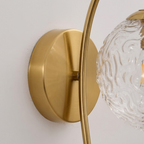 Detail View of Brushed Brass Backplate and Curved Light Arm