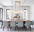 Modern Brass Wave Art Glass Linear Chandelier with Pearls in Classic Dining Setting