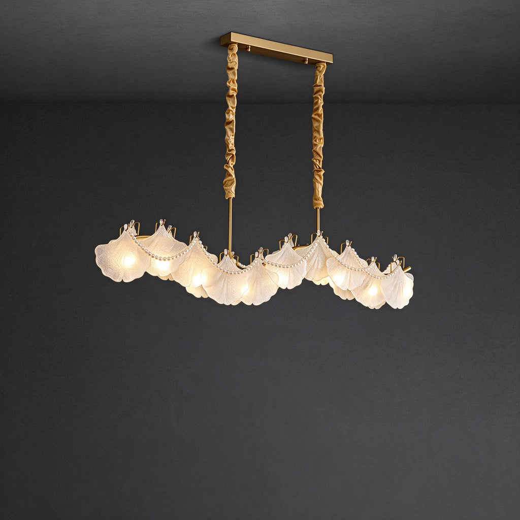 Illuminated Modern Brass Wave Art Glass Linear Chandelier with Pearl Strand Studio Shot on Dark Background