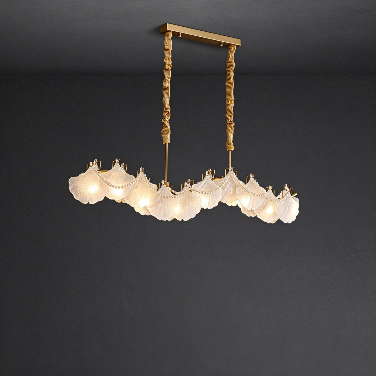 Illuminated Modern Brass Wave Art Glass Linear Chandelier with Pearl Strand Studio Shot on Dark Background