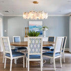 Modern Brass Feather Wave Chandelier Over Round Dining Table