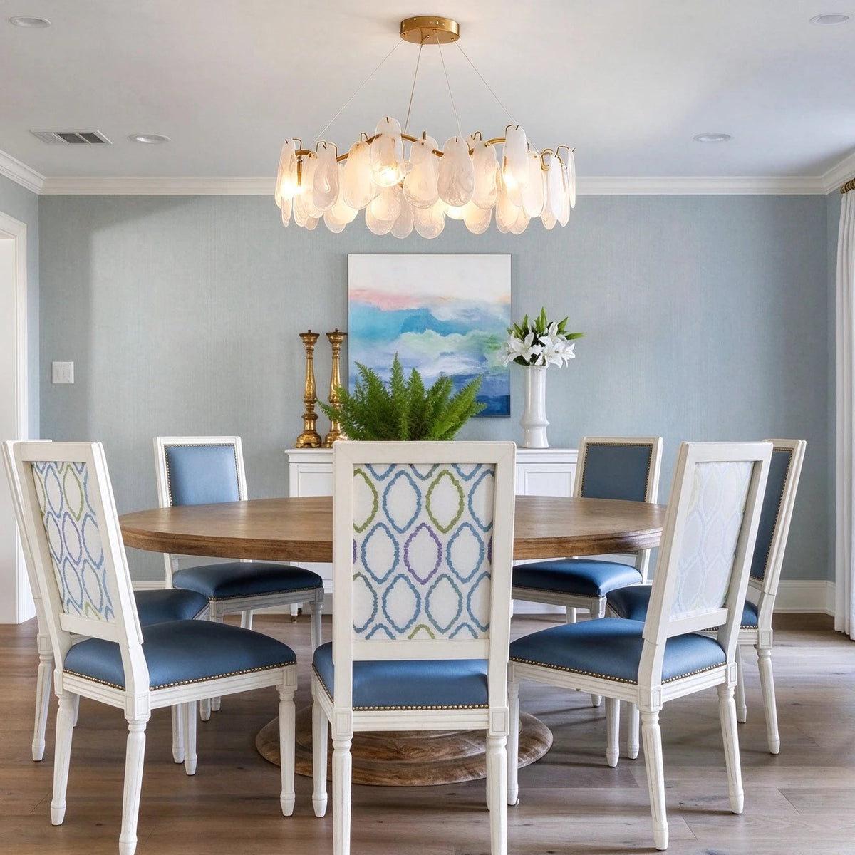 Modern Brass Feather Wave Chandelier Over Round Dining Table