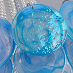 Close Up View of Blue Disc Glass Shades and Internal Bulbs Structure