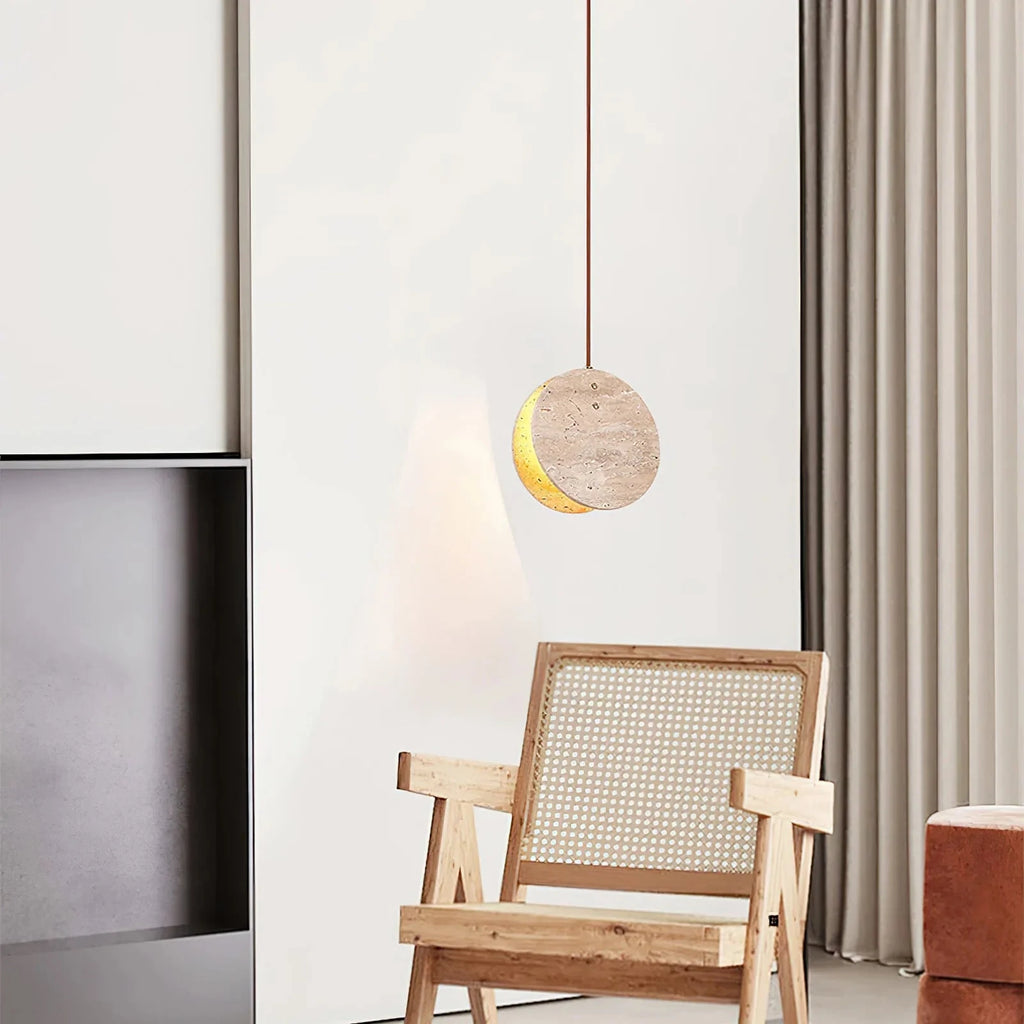Modern Travertine Disc Pendant Light Over Living Room Armchair
