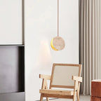 Modern Travertine Disc Pendant Light Over Living Room Armchair