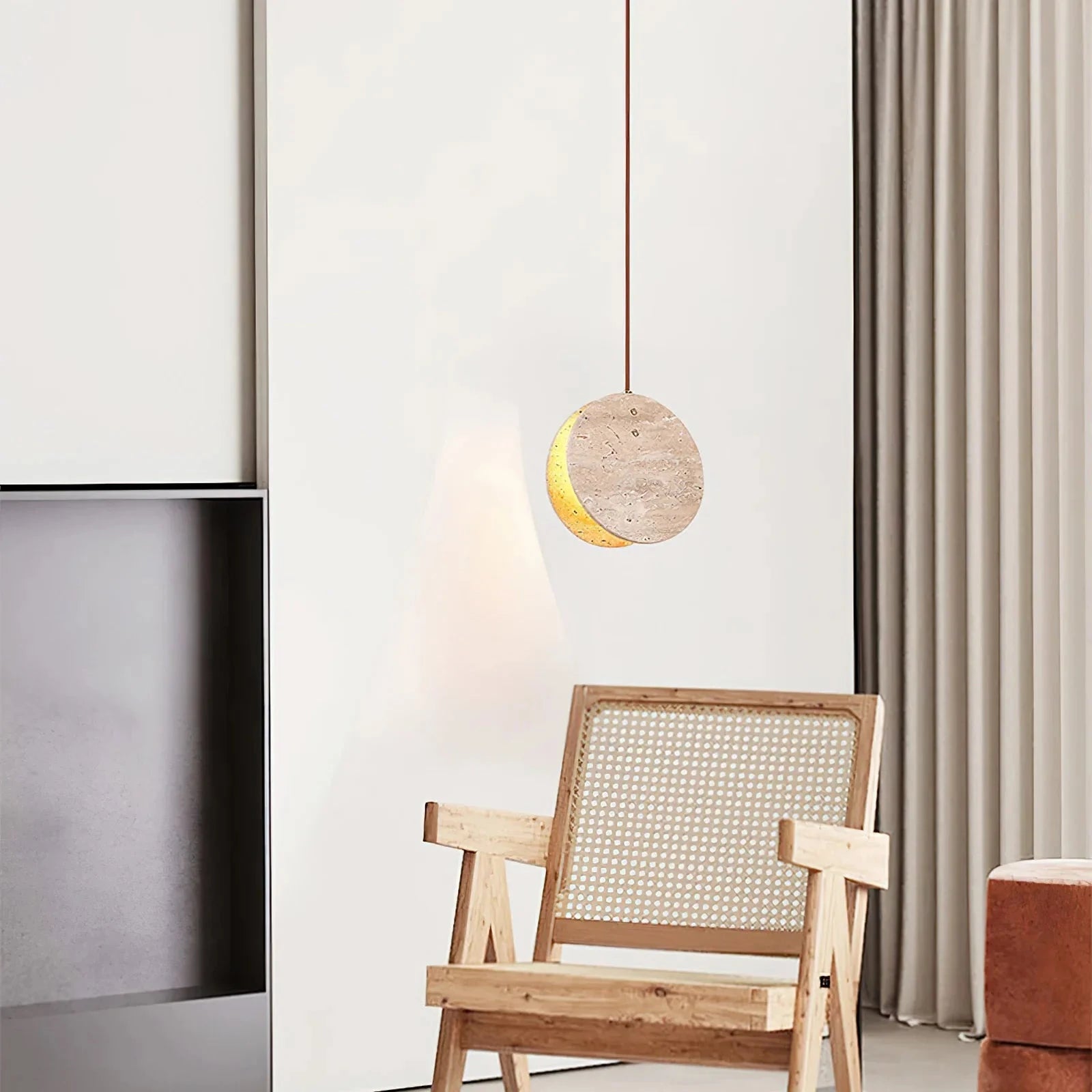 Modern Travertine Disc Pendant Light Over Living Room Armchair