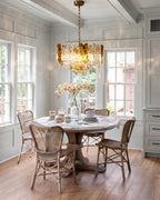 Modern Cascading Amber Art Glass Chandelier Over Dining Area