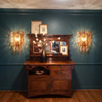 Modern Amber Art Glass Wall Sconces Over Wooden Cabinet