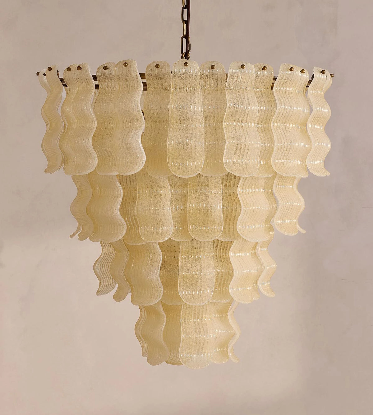 Side View of Illuminated Modern Beige Wavy Art Glass Chandelier