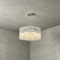 Side View of Illuminated Modern Cascading Cylindrical Glass Chandelier