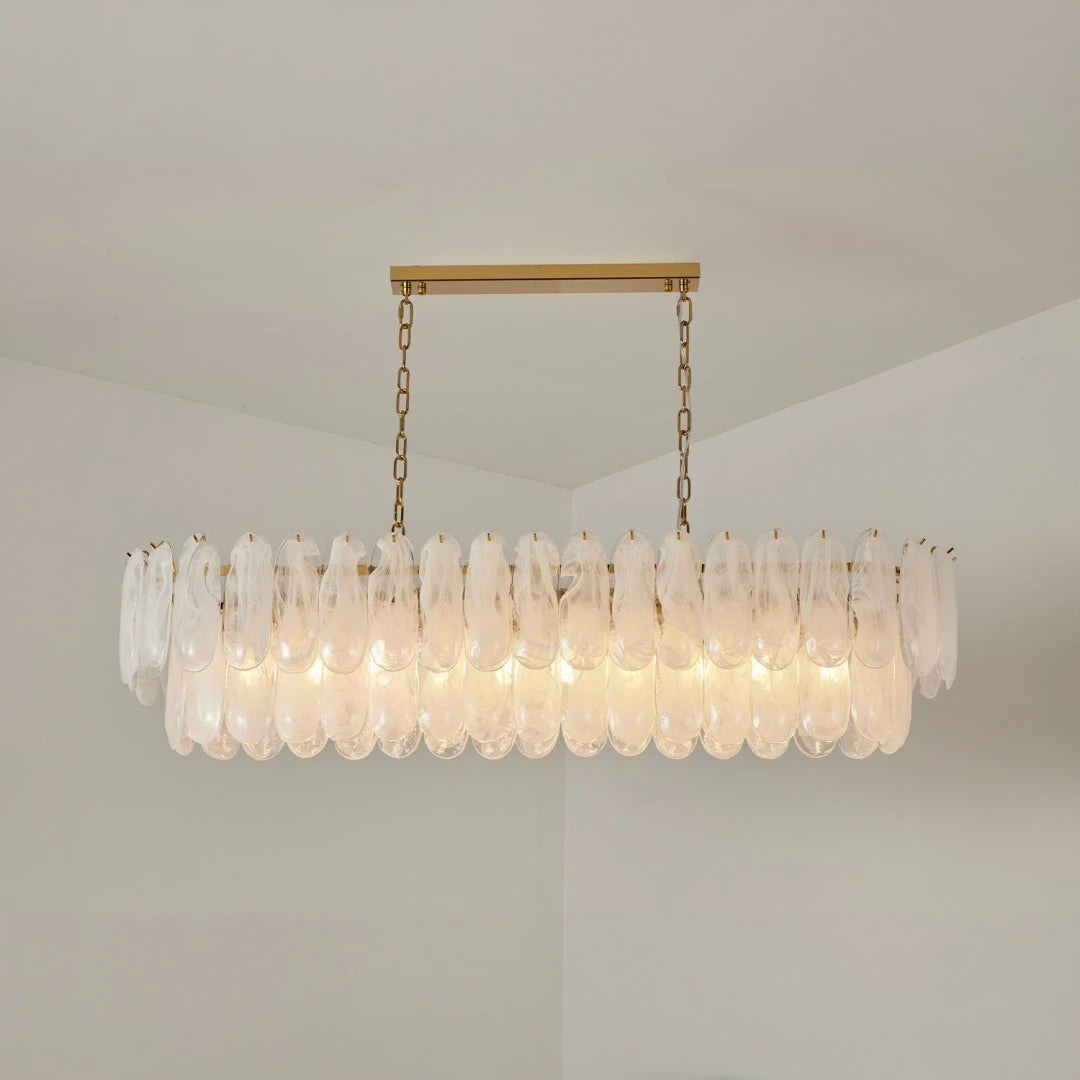 Angled View of Illuminated White Art Glass Linear Chandelier