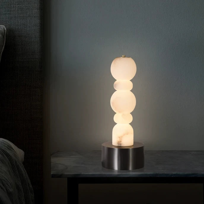 Illuminated Modern Black Base Alabaster Table Lamp Studio Shot on Dark Background