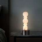 Illuminated Modern Black Base Alabaster Table Lamp Studio Shot on Dark Background