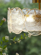 Close Up View of Textured Round Plate Art Glass Shades and Brass Hardware