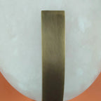 Close Up View of Brass Bracket and Oval Alabaster Stone Texture