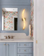 Modern S-Curved Alabaster Wall Sconce in Bathroom Vanity Setting