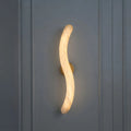 Illuminated Modern S-Curved Alabaster Wall Sconce Studio Shot