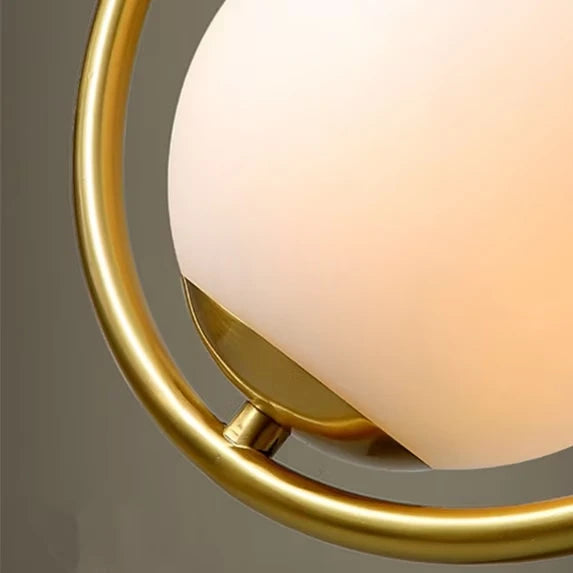 Close Up View of Brass Tear Drop Frame and Opal Glass Globe