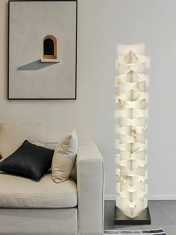Modern Stacked Alabaster Floor Lamp Over Cozy Sofa Corner
