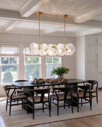 Modern Brass Layered Wave Disc Chandelier in Classic Dining Setting
