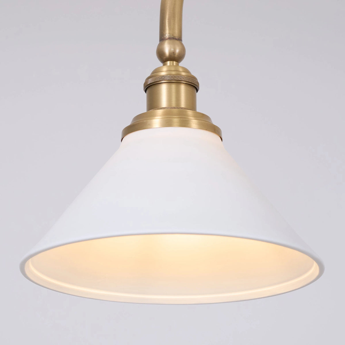 Front View of Illuminated Modern Brass Double-Head Pendant Light Studio Display