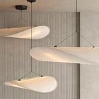 Modern Black Frame Cloud Wave Art Pendant Lights Against Wooden Slatted Wall