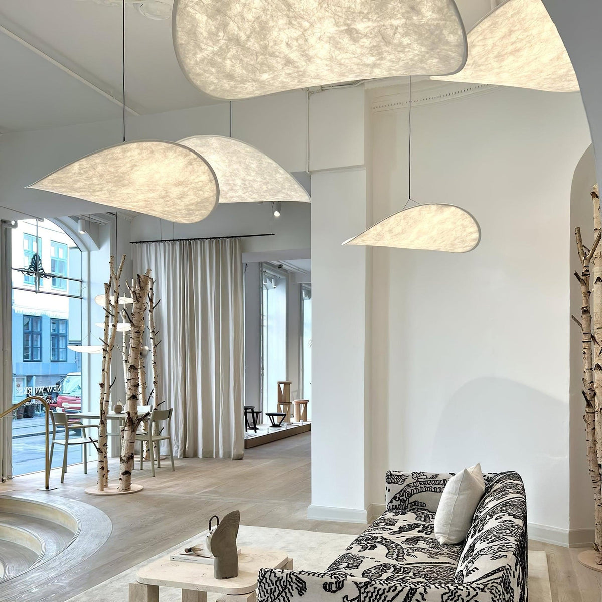 Layered Tense pendant lamps inside modern patterned sofa living room