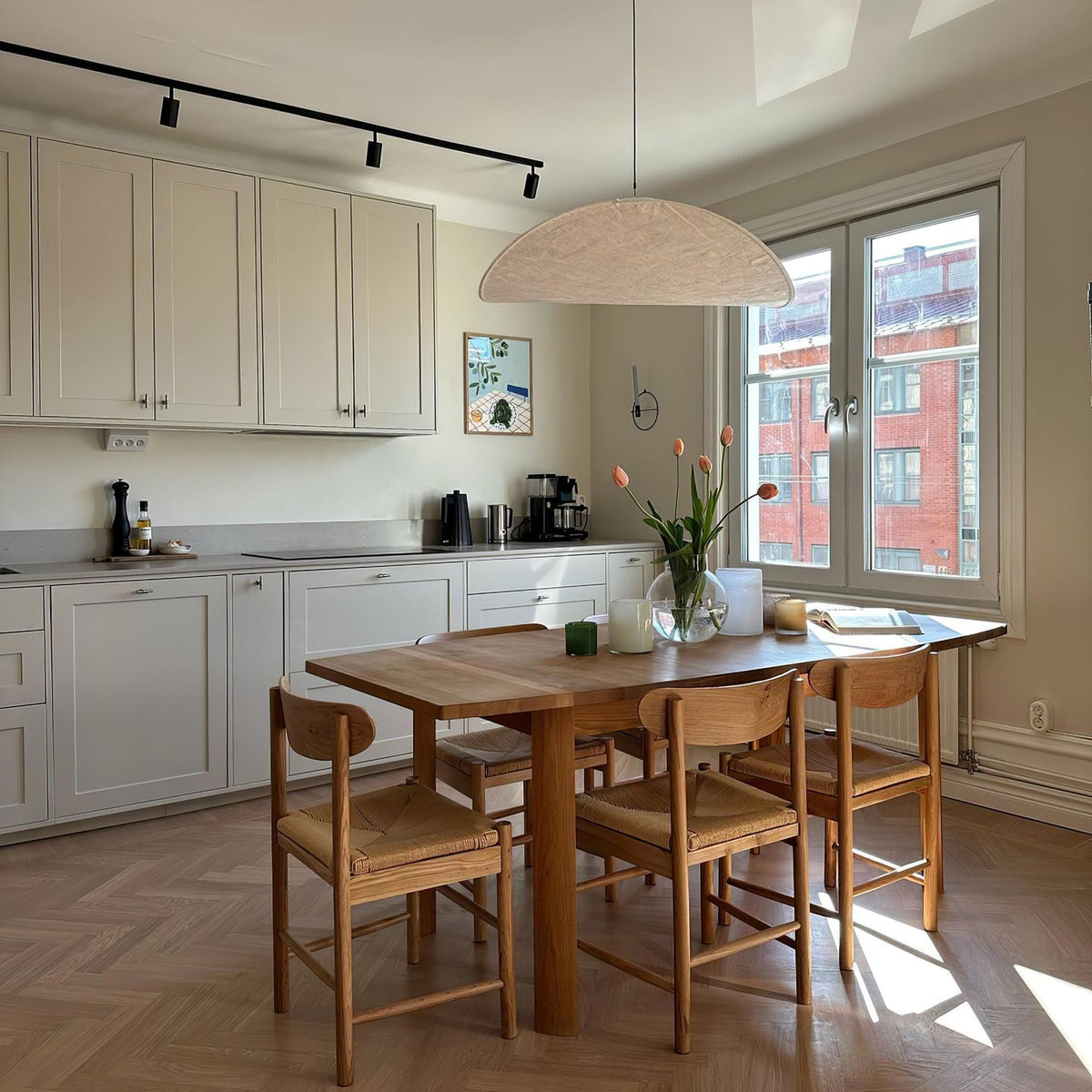 Tense Pendant Lamp hanging above wooden kitchen dining table